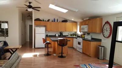 a kitchen with wooden cabinets and a counter top at Explore Amador and Calaveras County. in West Point