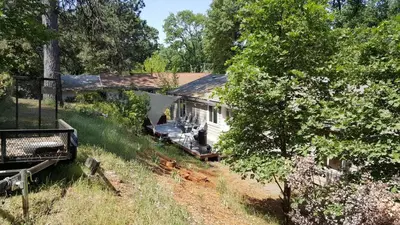an aerial view of a white house in the woods at Explore Amador and Calaveras County. in West Point