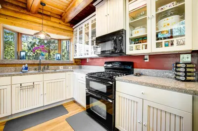 a kitchen with white cabinets and a stove at The Cub Inn in Groveland