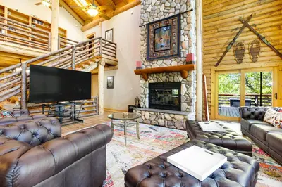 a living room with leather furniture and a fireplace at The Cub Inn in Groveland