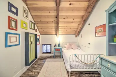 a bedroom with a bed and a wooden ceiling at Walk Downtown Arnold Cabin with Large Deck! in Arnold