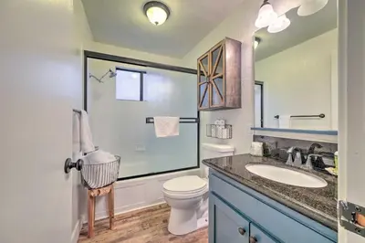 a bathroom with a toilet and a sink and a shower at Walk Downtown Arnold Cabin with Large Deck! in Arnold