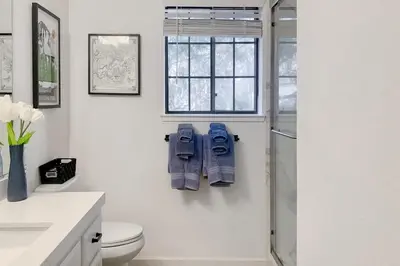 a bathroom with a shower and a toilet and a window at Fun In The Sun Cabin in Groveland