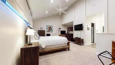 a bedroom with a bed and a dresser and a tv at St, Anton #54 condo in Mammoth Lakes