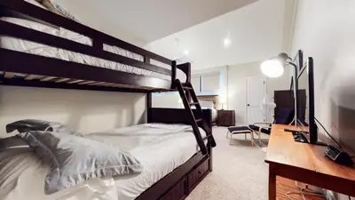 a bedroom with two bunk beds and a desk at St, Anton #54 condo in Mammoth Lakes
