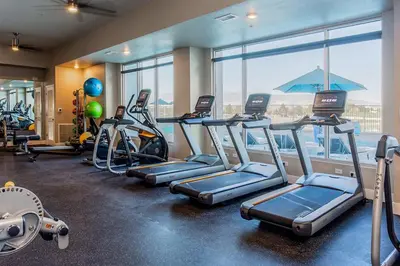 a gym with several tread machines and a large window at Chic Apt w Jacuzzi, Pool, BBQ, & Mountain Views in Sparks