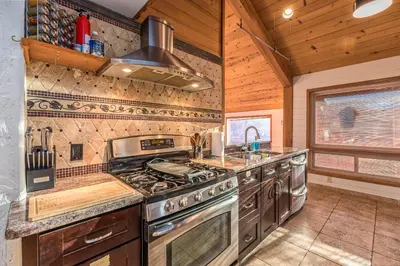 a kitchen with a stove and a sink at Red Oasis in Oakhurst