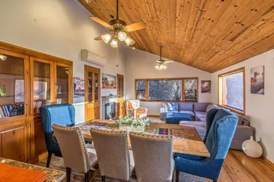 a dining room with a table and chairs and a couch at Red Oasis in Oakhurst