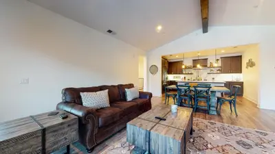 a living room with a couch and a table at Snowcreek VII #1403 condo in Mammoth Lakes