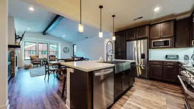 a kitchen with wooden cabinets and stainless steel appliances at Snowcreek VII #1403 condo in Mammoth Lakes