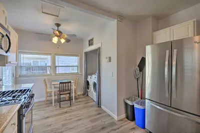 a kitchen with a stainless steel refrigerator and a dining room at Pet-Friendly Sacramento Home about 5 to Downtown! in Sacramento
