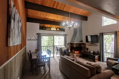 a living room with a couch and a table at Woodsy retreat near Northstar & lake in Kings Beach