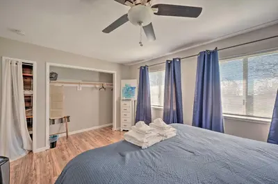 a bedroom with a blue bed with blue curtains at Authentic Escape at the Exact Center of CA! in North Fork