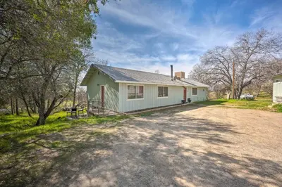 a house with a dirt road in front of it at Authentic Escape at the Exact Center of CA! in North Fork