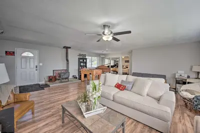a living room with a couch and a ceiling fan at Authentic Escape at the Exact Center of CA! in North Fork