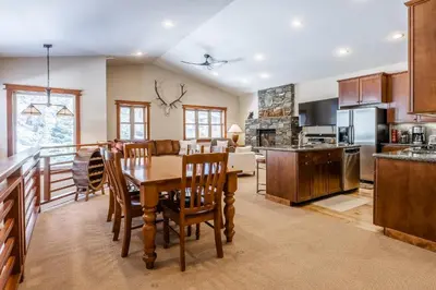 a kitchen and living room with a table and chairs at Newly Updated Red Slate 4 is a 4 Bedrm 3 full Bathrm Townhome Close to Canyon Lodge That Sleeps 10 in Mammoth Lakes