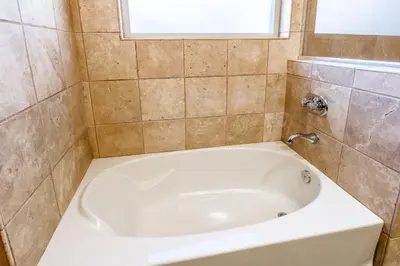a white bath tub in a bathroom with a window at Newly Updated Red Slate 4 is a 4 Bedrm 3 full Bathrm Townhome Close to Canyon Lodge That Sleeps 10 in Mammoth Lakes