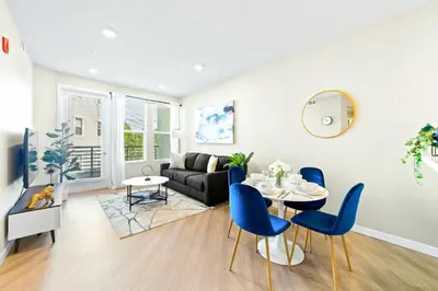 a living room with a couch and a table and chairs at Designer Apt with Jacuzzi, Sky Lounge, Gym Access in Sparks