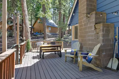 a wooden deck with a table and chairs on it at 3 Mi to Big Trees State Park Cabin with Scenic Deck in Arnold