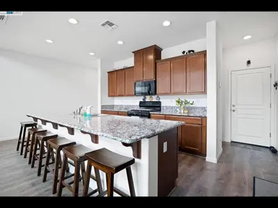 a kitchen with a large island with bar stools at Madera lovely home in Madera