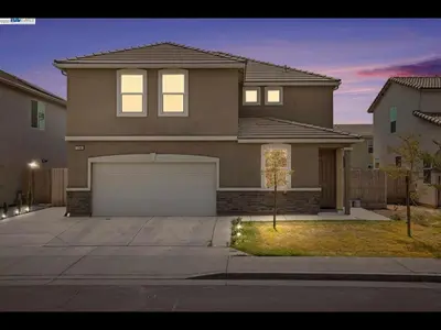 a large house with a garage in front of it at Madera lovely home in Madera