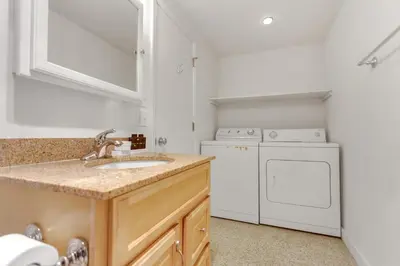 a kitchen with a sink and a washer and dryer at Stylish, Remodeled Condo - Creekside #14 in Bear Valley