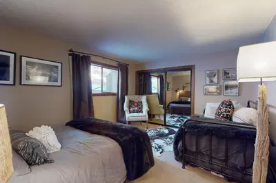 a bedroom with a bed and a living room at The Chalet in Zephyr Cove