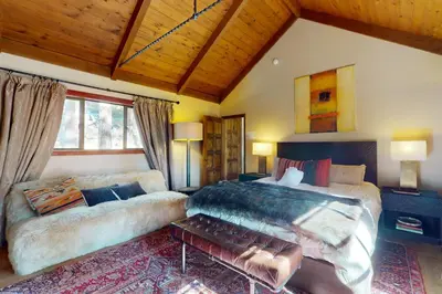 a large bedroom with a large bed and a couch at The Chalet in Zephyr Cove