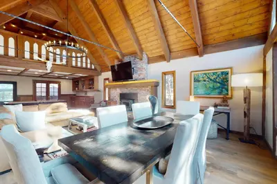 a living room with a table and chairs and a fireplace at The Chalet in Zephyr Cove