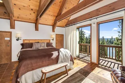 a bedroom with a bed and a balcony at Overlooking Beautiful Bear Lake VH#318 in Bear Valley