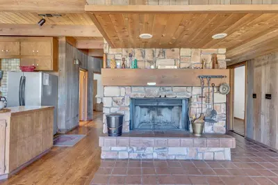 a living room with a stone fireplace in a house at Overlooking Beautiful Bear Lake VH#318 in Bear Valley