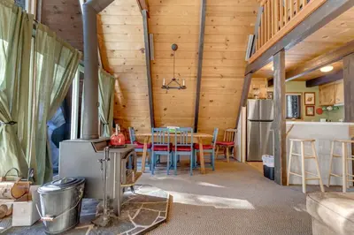 a kitchen and dining room with a table and chairs at Popular A-frame Cabin With Deck & Views - Vh 216 in Bear Valley