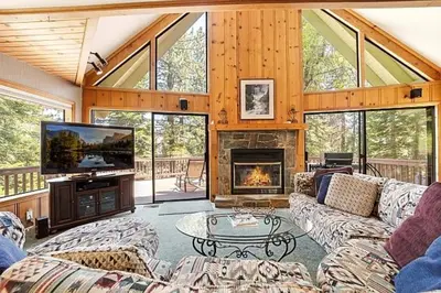 a living room with couches and a tv and a fireplace at Spacious Cabin Sleeps up to 12 - Sky High #86 in Bear Valley
