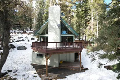 a tiny house in the woods in the snow at Spacious Cabin Sleeps up to 12 - Sky High #86 in Bear Valley