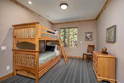 a bedroom with a bunk bed and a desk at Modern Condo - Jacuzzi Tub SM #201 in Bear Valley