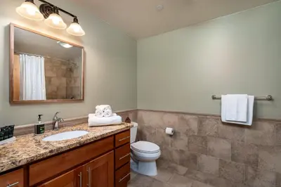 a bathroom with a sink and a toilet at Modern Condo - Jacuzzi Tub SM #201 in Bear Valley