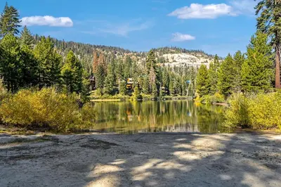 a lake with trees and a mountain in the background at Modern Condo - Jacuzzi Tub SM #201 in Bear Valley
