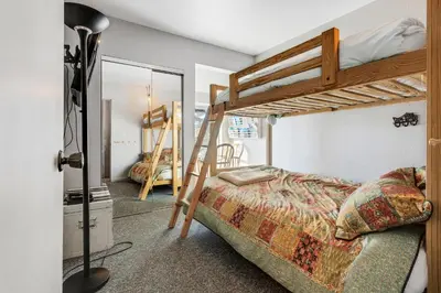 a bedroom with two bunk beds and a mirror at Great Location Corner Condo - Tamarack #10 Pets Ok in Bear Valley