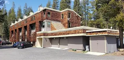 a brick building with a car parked in front of it at Comfortable Condo Great Location- Tamarack #12 in Bear Valley