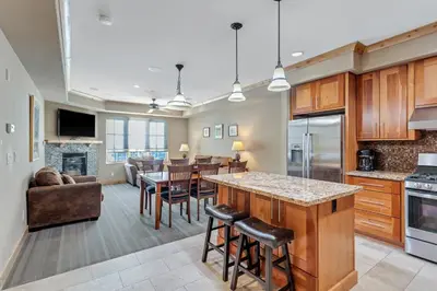 a kitchen and living room with a table and chairs at Modern Condo - Great Location! in Bear Valley