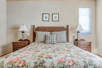 a bedroom with a bed and two night stands with lamps at Modern Condo - Great Location! in Bear Valley