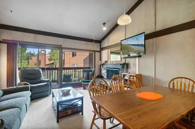 a living room with a table and a couch at Relaxing, Well Furnished Condo! - Creekside #29 in Bear Valley