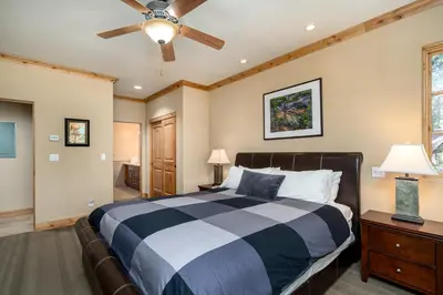 a bedroom with a bed and a ceiling fan at Luxurious Modern Condo! - SM #207 in Bear Valley