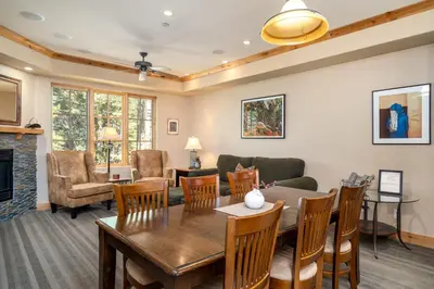 a living room with a table and chairs and a couch at Luxurious Modern Condo! - SM #207 in Bear Valley