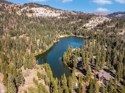 an aerial view of a lake in a forest at Modern & Sleek Condo - Creekside #110 in Bear Valley