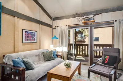 a living room with a couch and a chair at Sunny, Spacious & Pet Friendly - Creekside #39 in Bear Valley