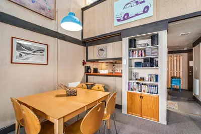 a dining room with a wooden table and chairs at Sunny, Spacious & Pet Friendly - Creekside #39 in Bear Valley