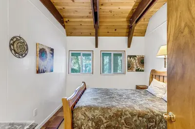 a bedroom with a bed and two windows at Multi-Family Cabin in Great Location #183 in Bear Valley