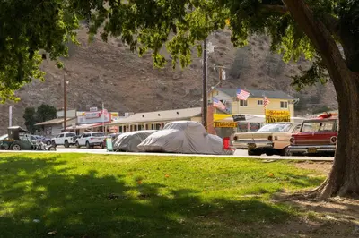 a park with tents and cars parked in a parking lot at Epic View A Luxury House on a Hill River 10 min in Kernville