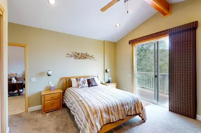 a bedroom with a bed and a large window at Murray Lake Retreat in Bass Lake